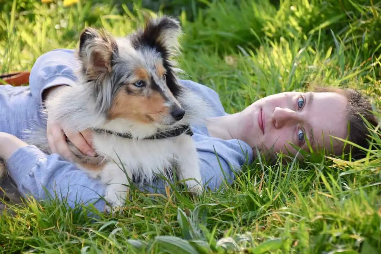 owner lying on ground with dog
