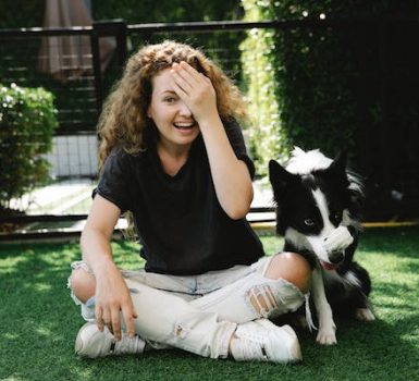 woman with a border collie doing tricks