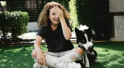woman with a border collie doing tricks